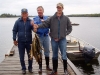 Three men with a big supper of fish