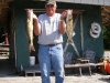 Happy fisherman holding up his catch.